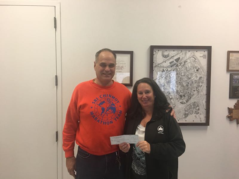 Donation Check Presented to Janice Melnick from Sri Chinmoy Marathon Team